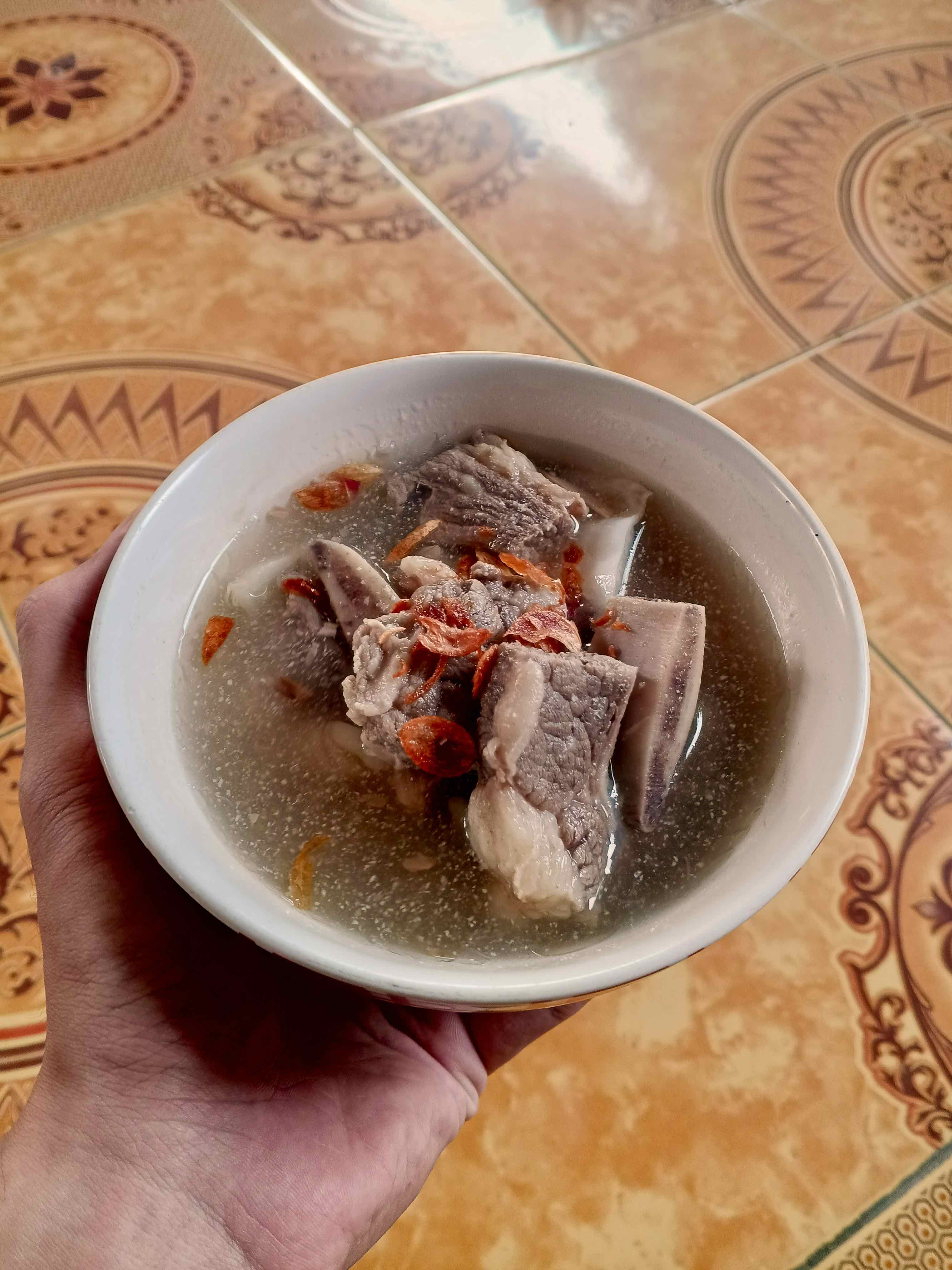 Tumis sawi udang served in a white melamine bowl