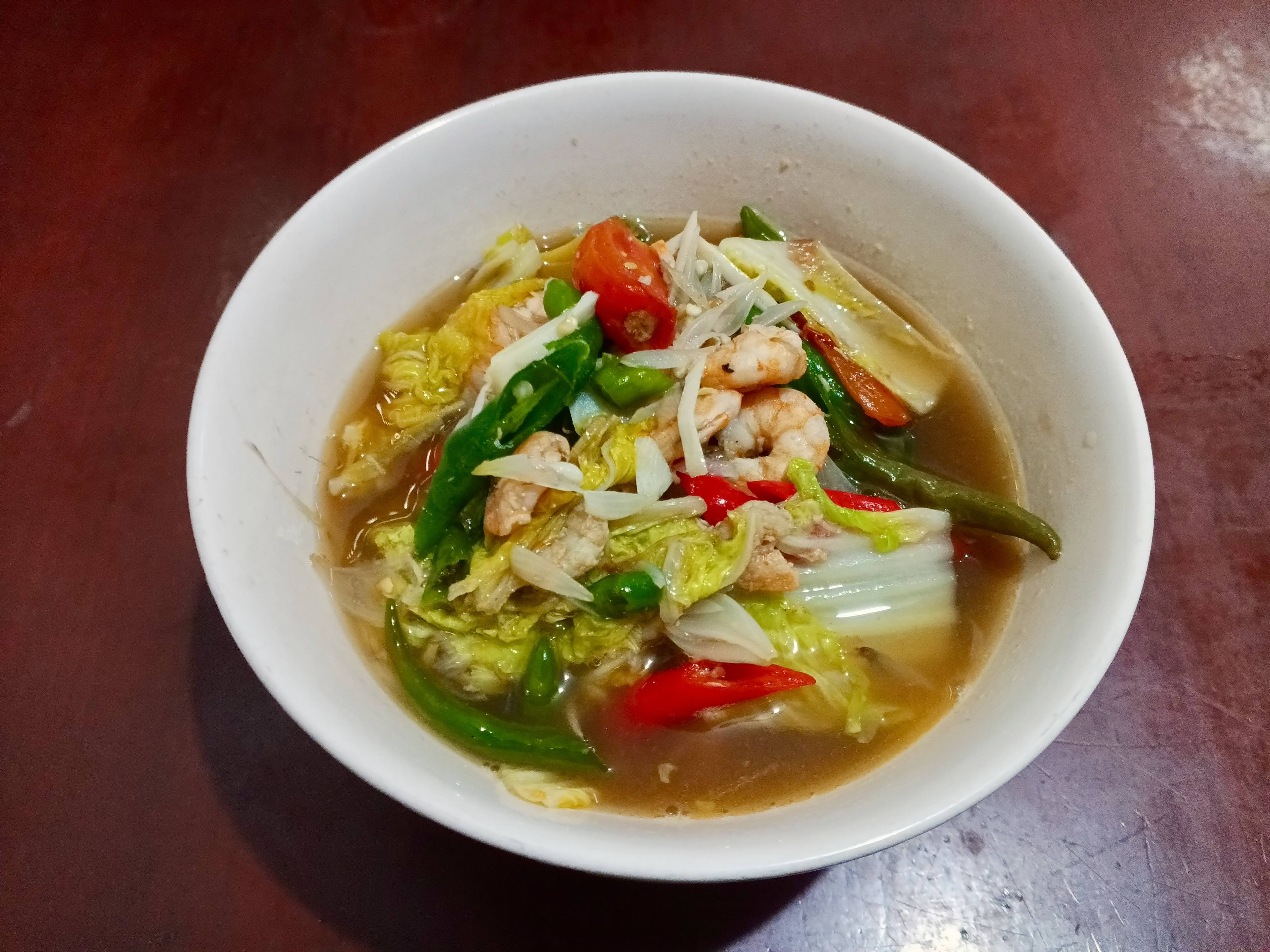 Tumis sawi udang served in a white melamine bowl